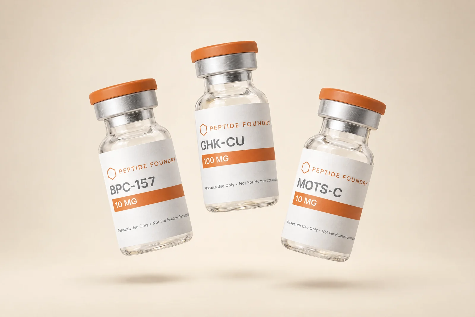 BPC-157, GHK-CU, and MOTS-C vials floating in a warm cream studio